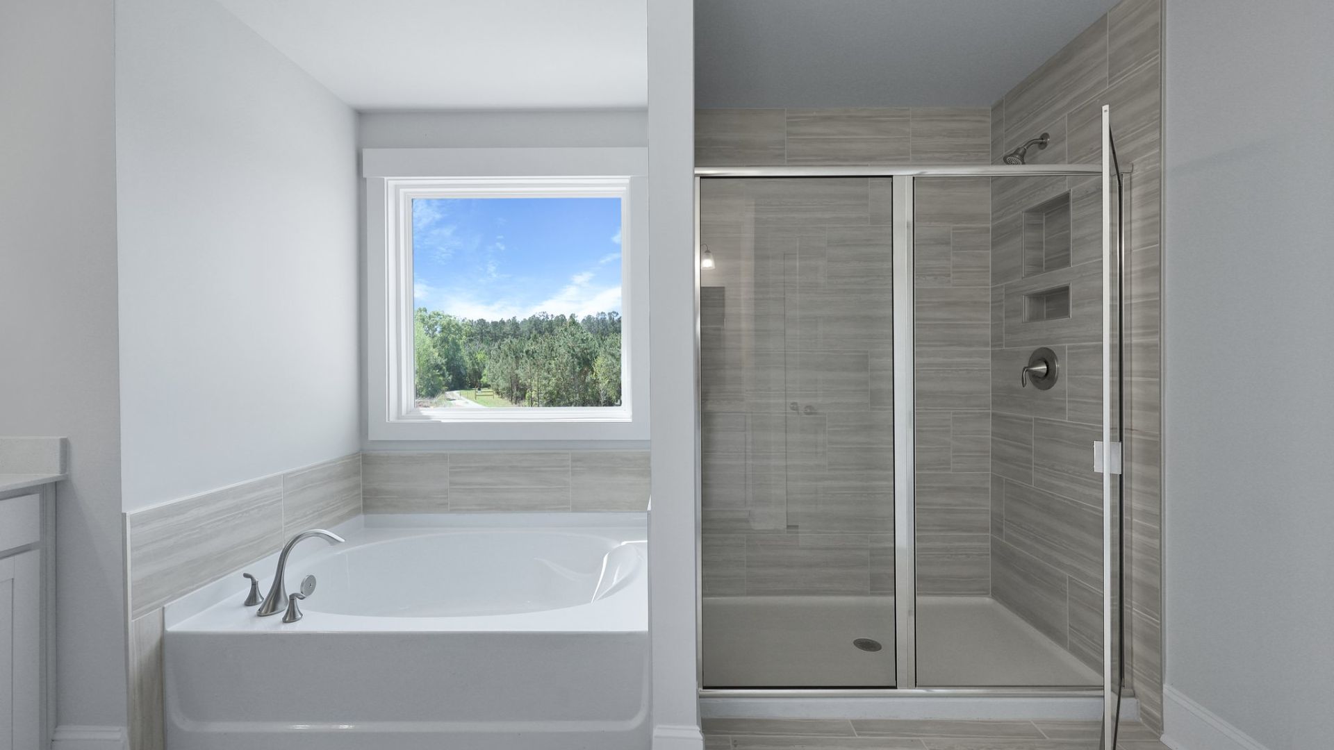 The standup shower and tub are located in the primary bathroom.