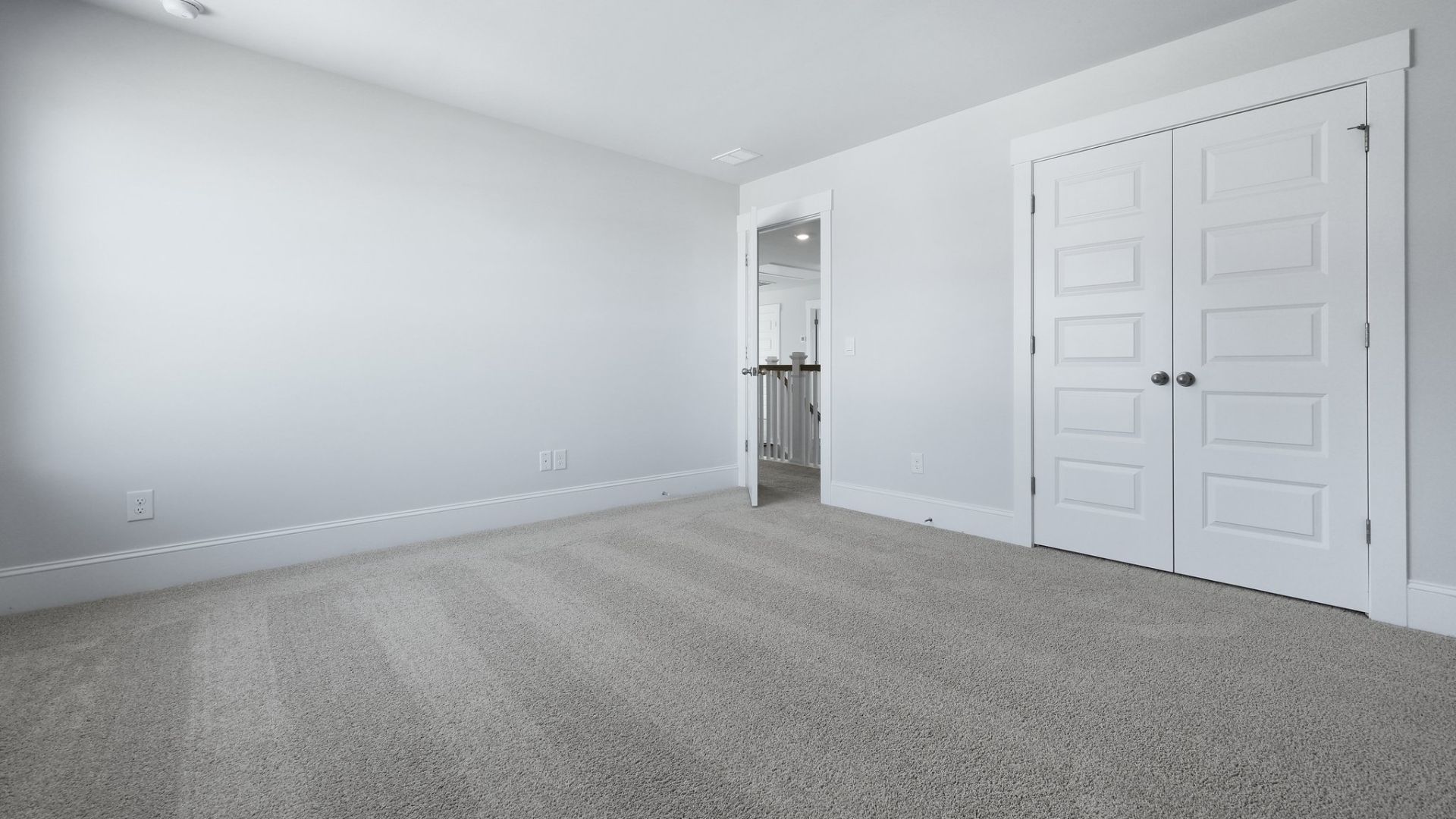 Bedroom 2 is located upstairs and is carpeted with windows for natural lighting.