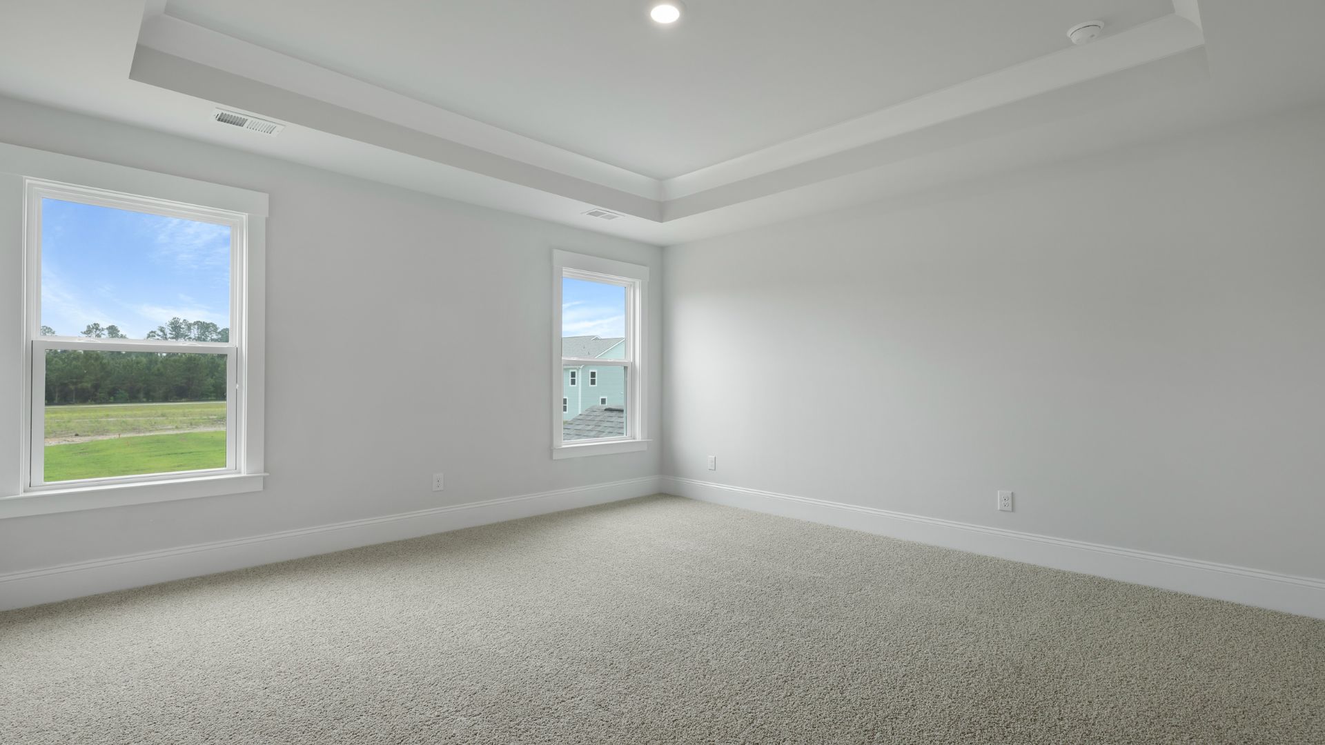 primary bedroom with tray ceilings