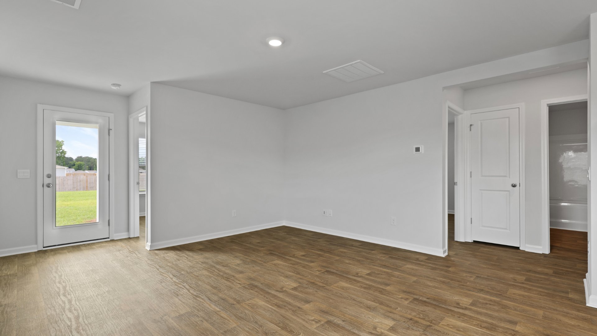 Living room with door leading to the backyard