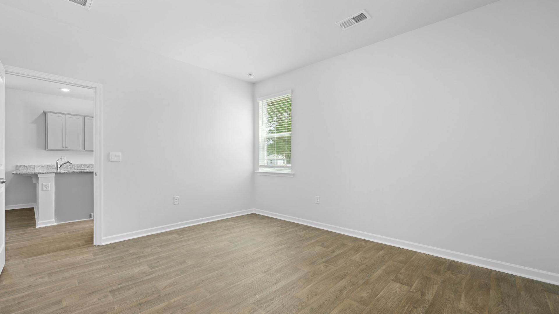 The primary bedroom is located off of the kitchen for comfort and easy access.