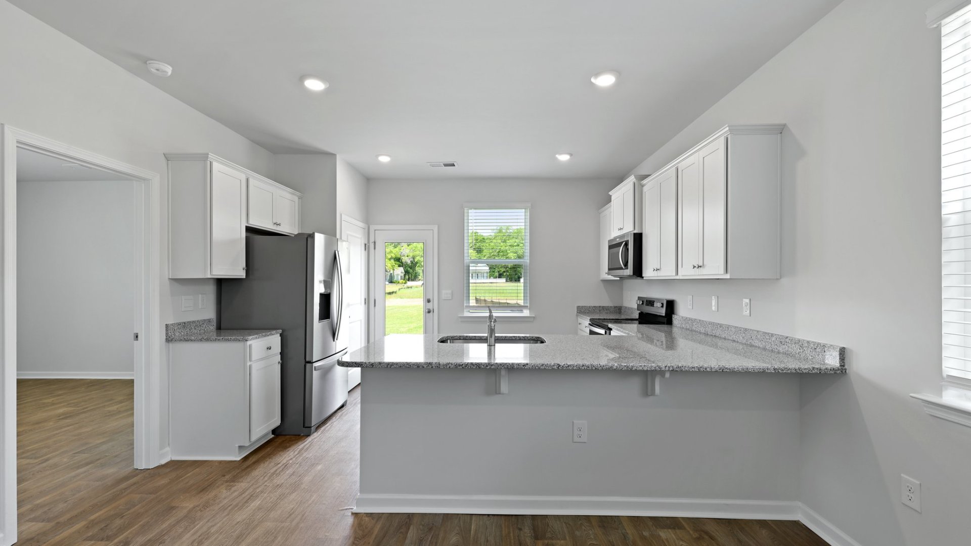 The perry floorplan has a spacious and open concept living area with a peninsula in the kitchen.