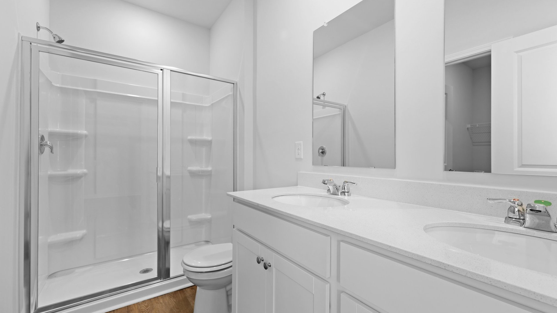 Primary bathroom with standup walk-in shower and dual vanitites.