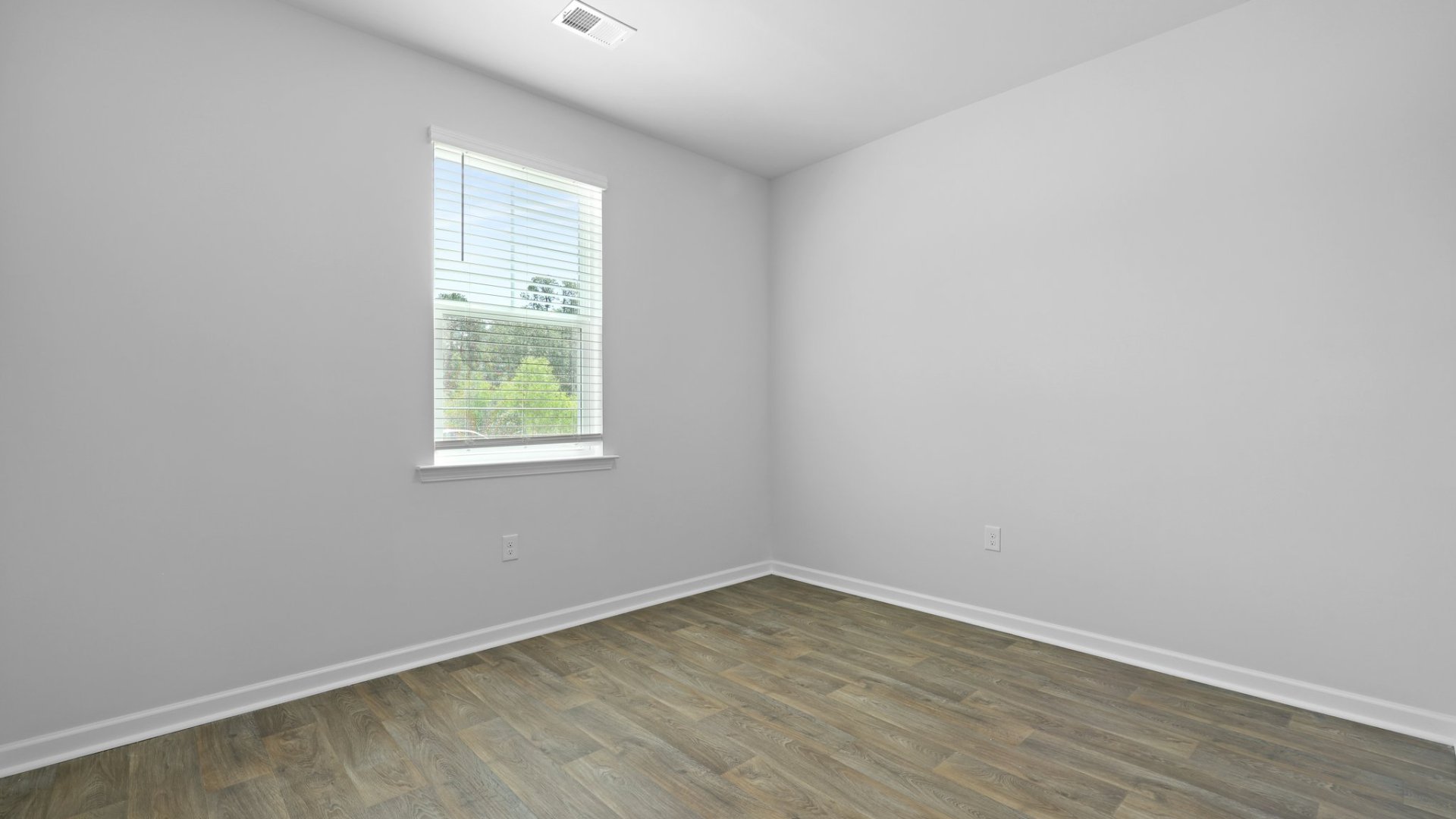 Bedroom 2 has hardwood and is located across from the second full bathroom.