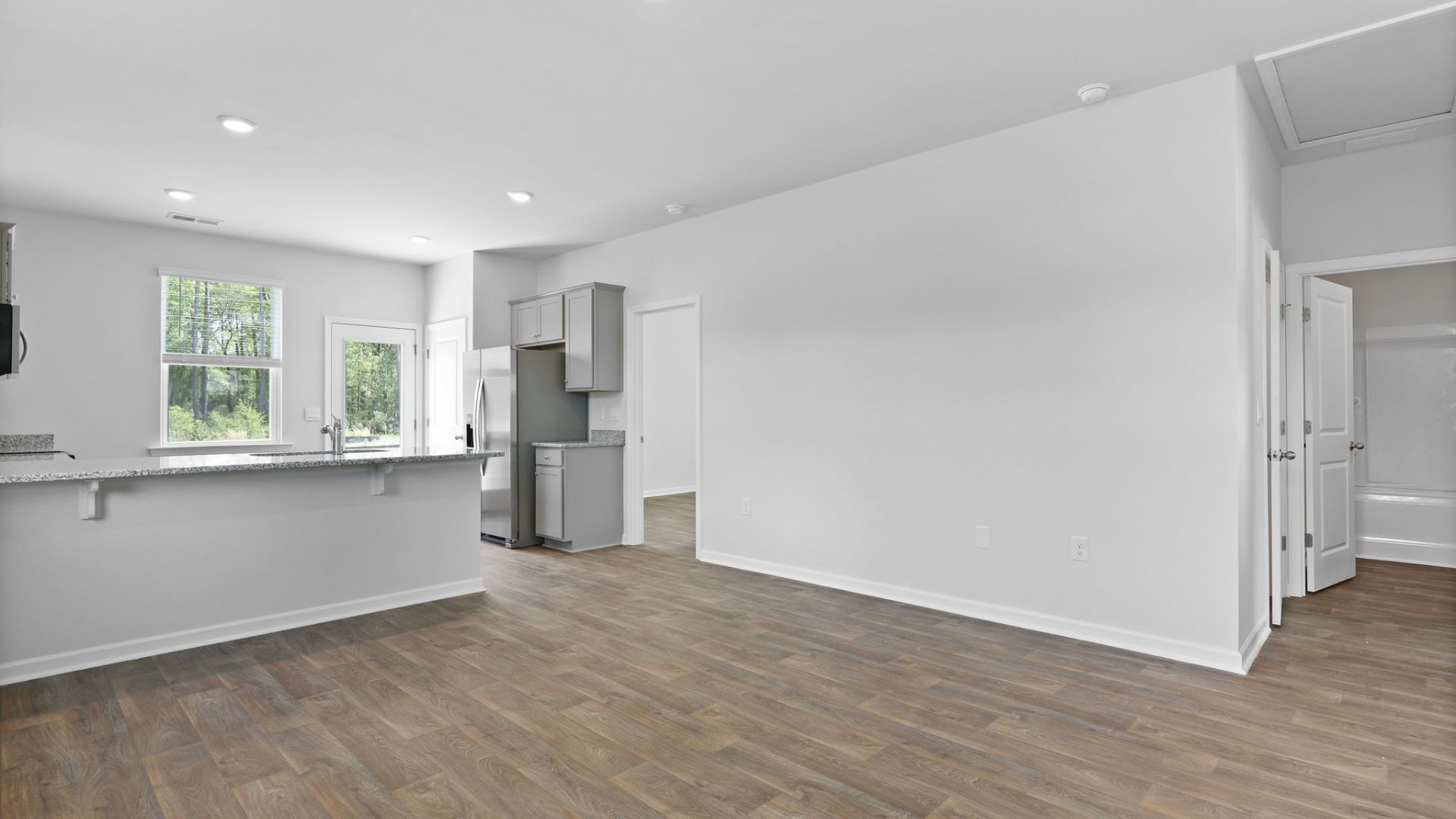 Open concept and bright living room, dining room and kitchen.