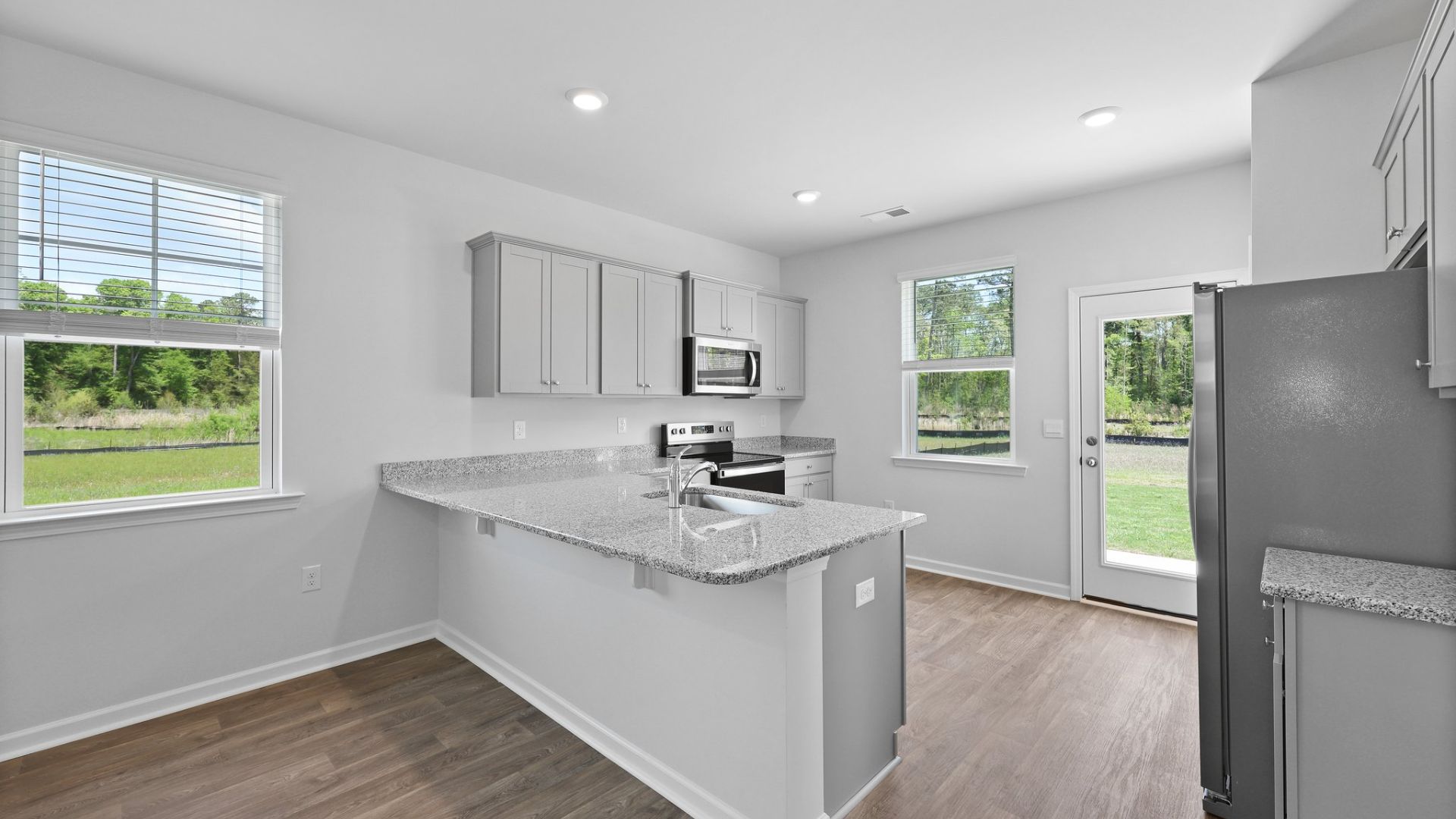 Spacious and naturally lit kitchen with a peninsula.