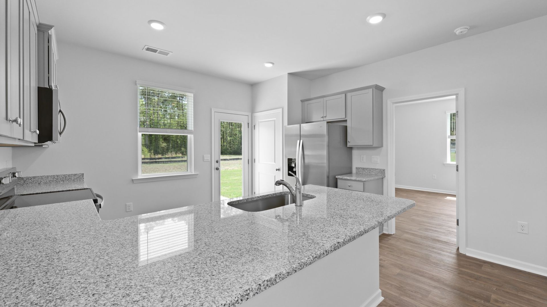 The primary bedroom is located off of the kitchen for easy access.