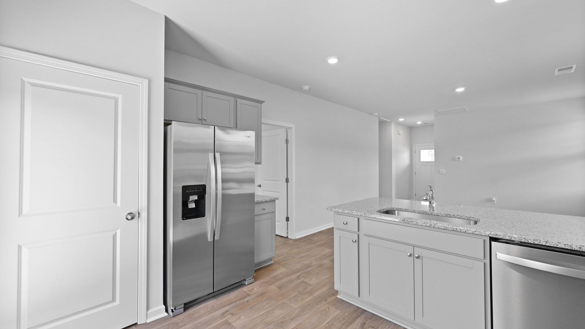 Sleek cabinets and a pantry in the kitchen.