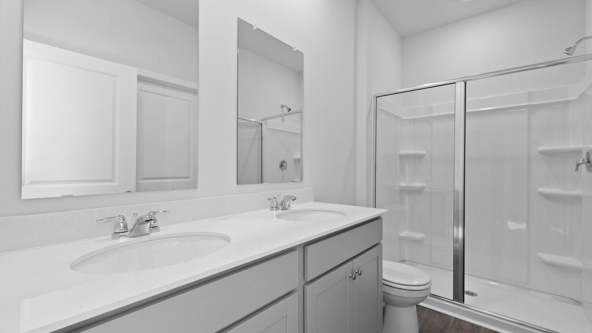 Dual vanities and a standup walk-in shower in the primary bathroom.