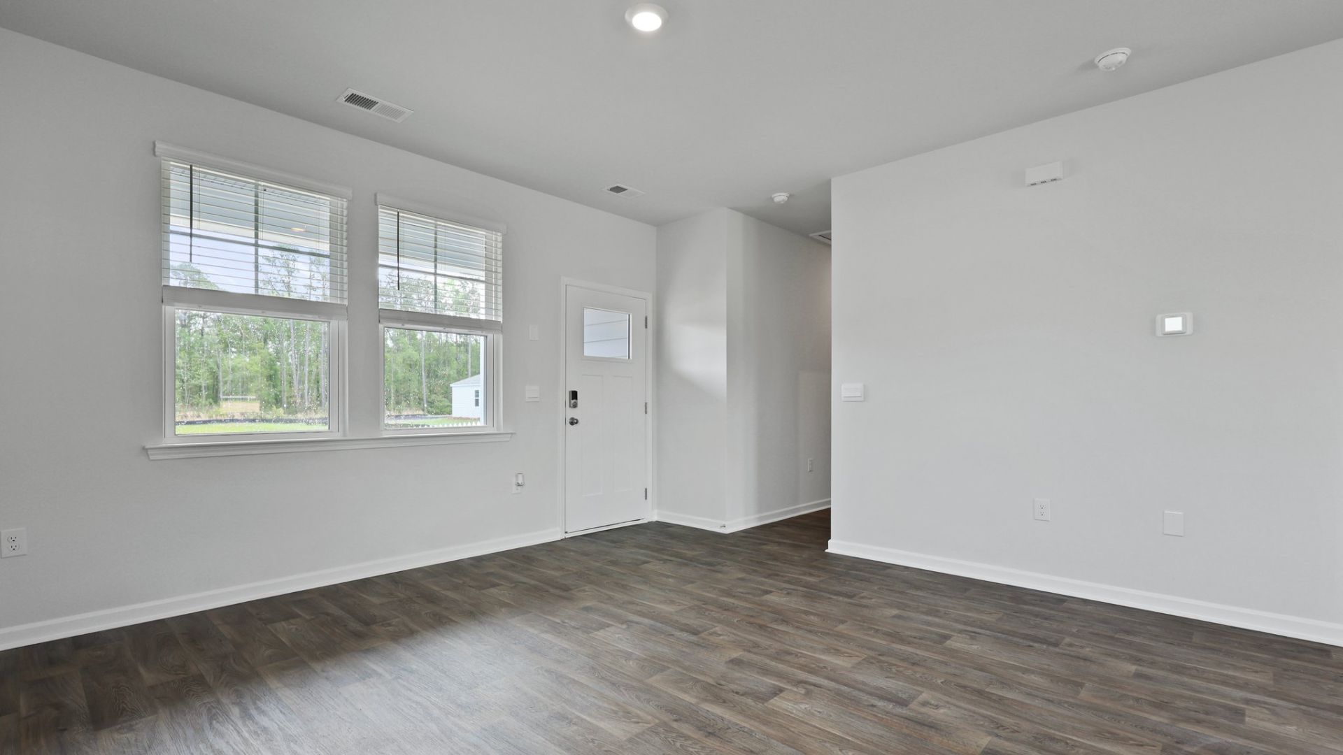 The entry way of the Curtis floorplan is bright from windows.
