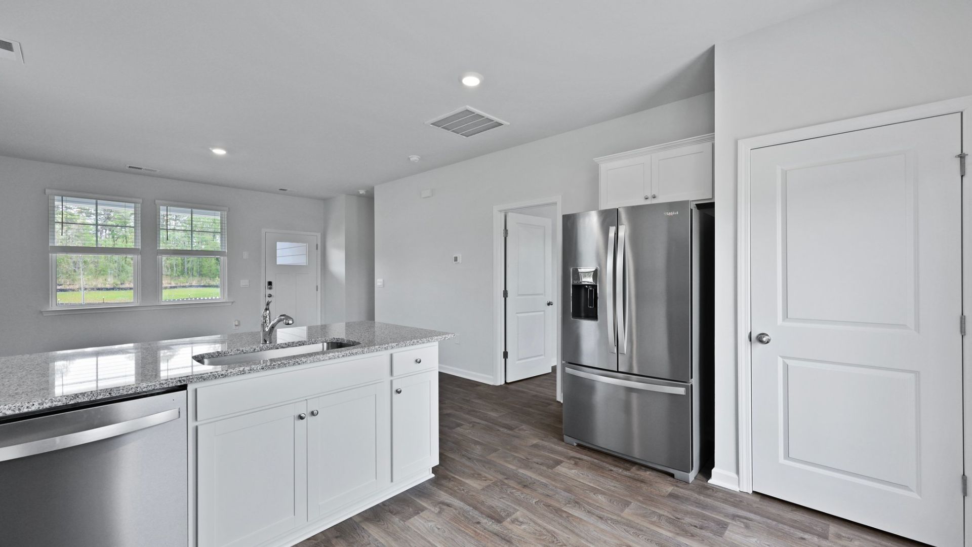 The pantry for storage as well as the stainless steel fridge.