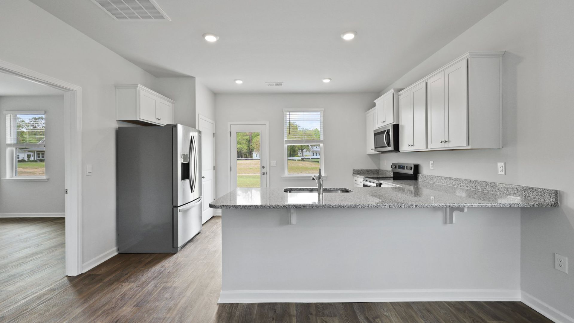 The primary bedroom is off of the kitchen for easy access.