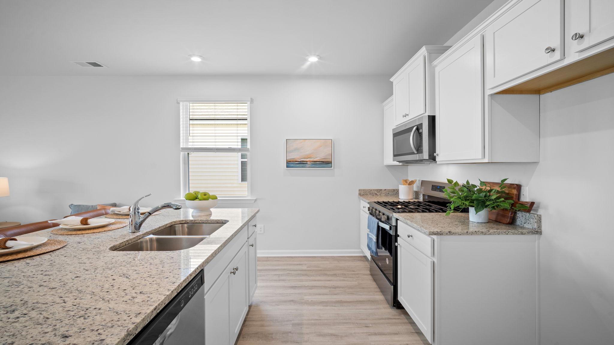Spacious kitchen in the Greenbriar floor plan with large island, modern cabinetry, stainless steel appliances, and open-concept living.