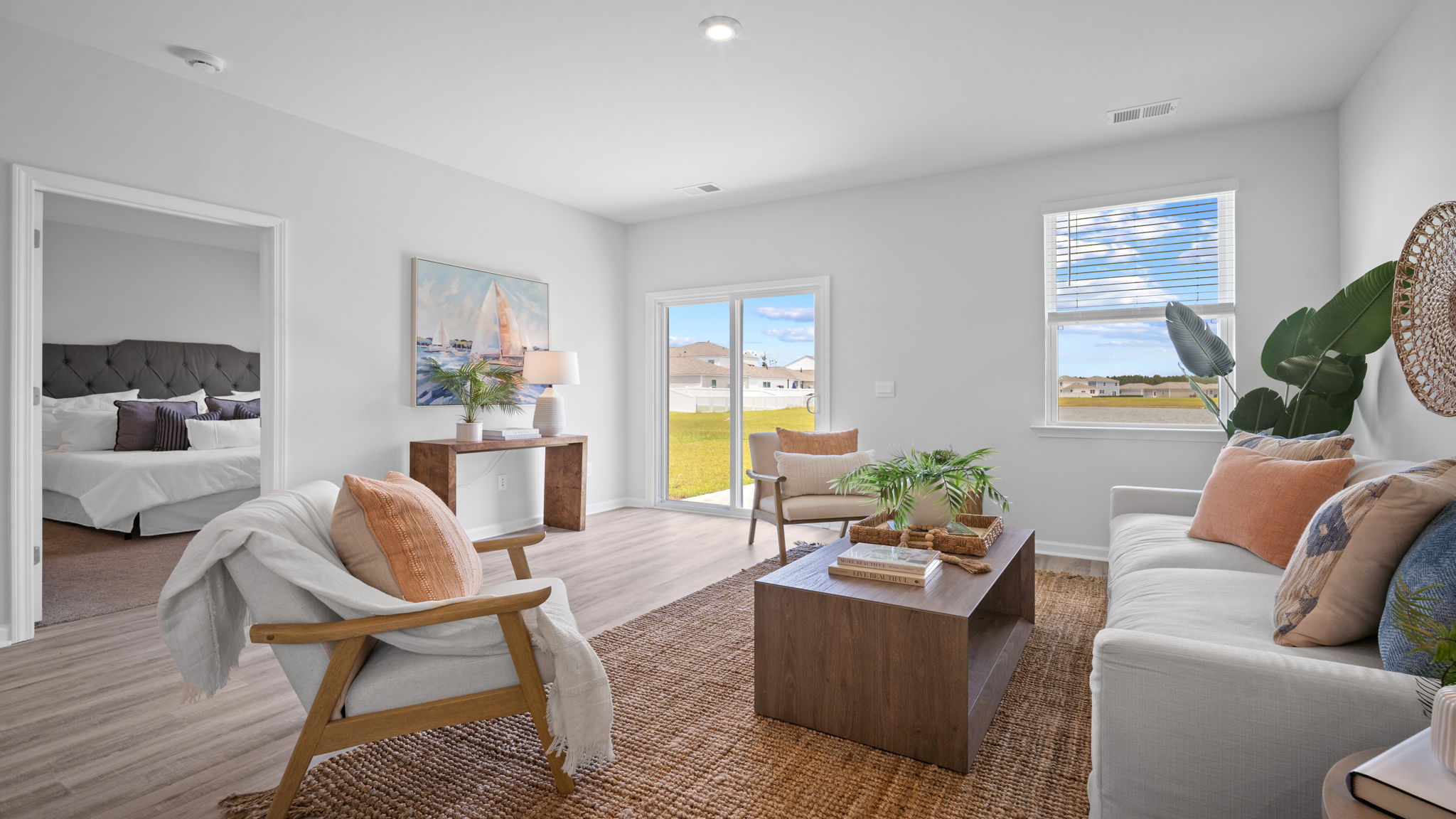 Modern family room in the Greenbriar by D.R. Horton connected to the kitchen and dining area