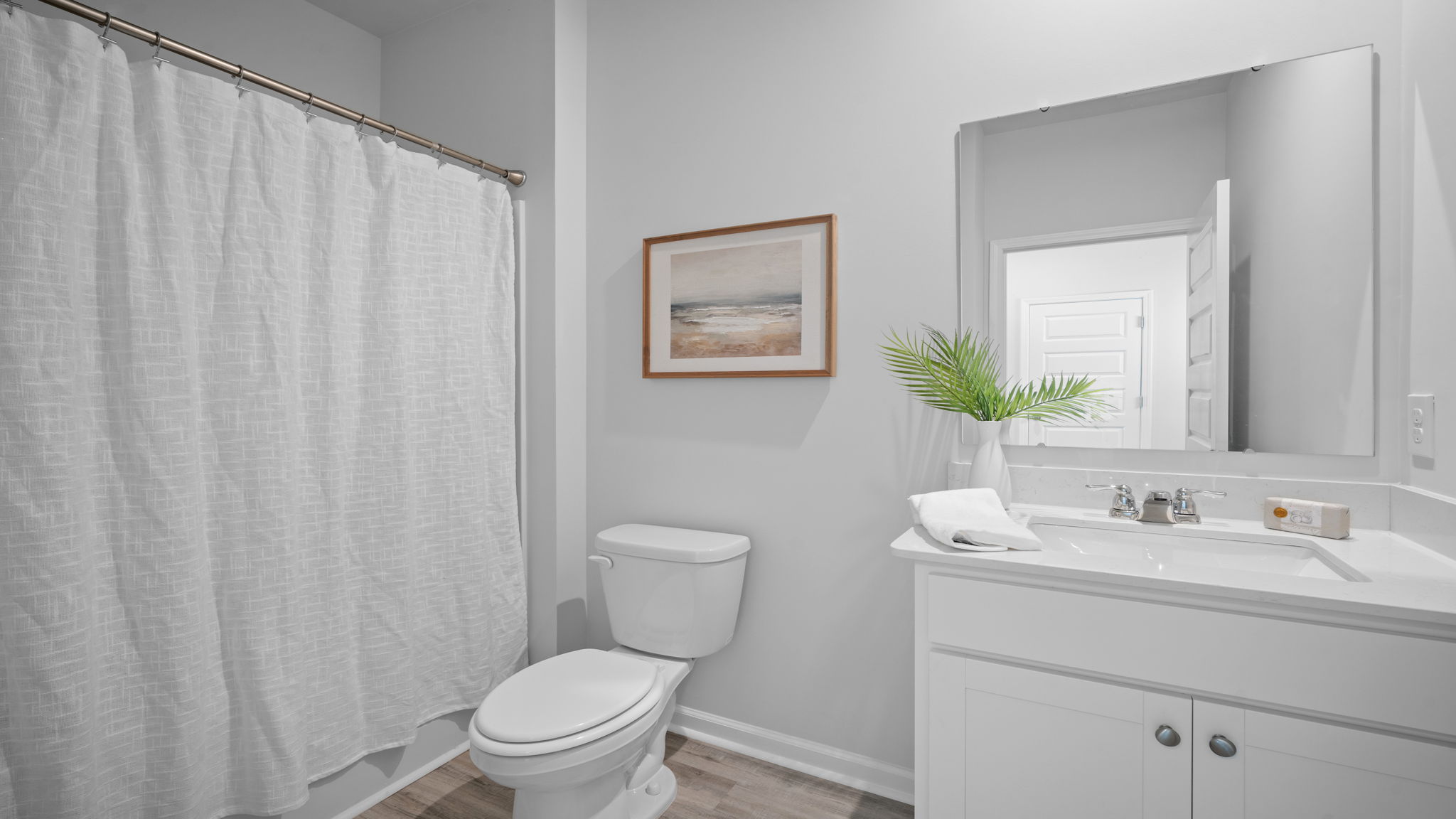 Full guest bathroom in the Greenbriar floor plan with modern fixtures and functional design
