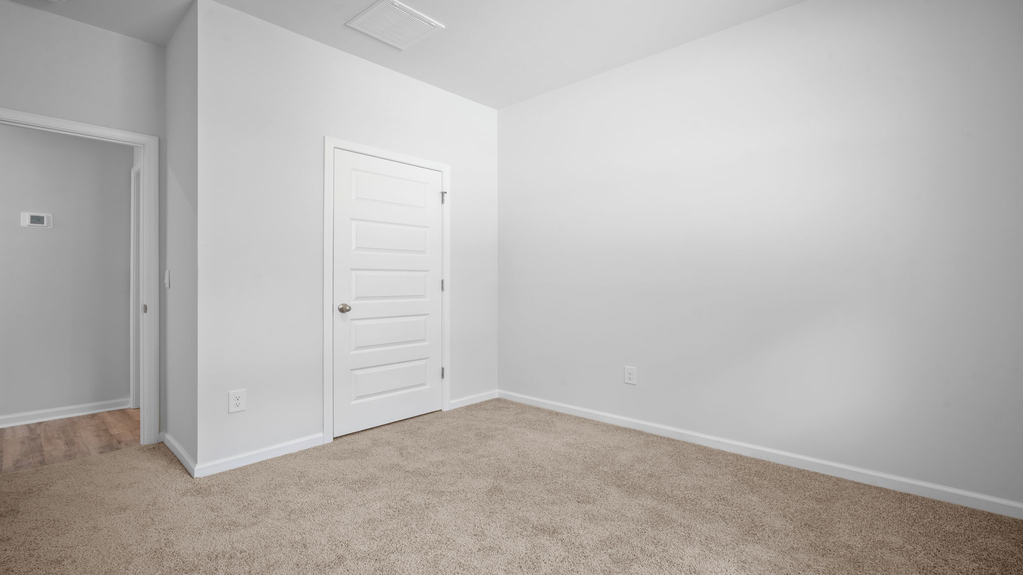 Bright guest bedroom in the Greenbriar floor plan with versatile living space