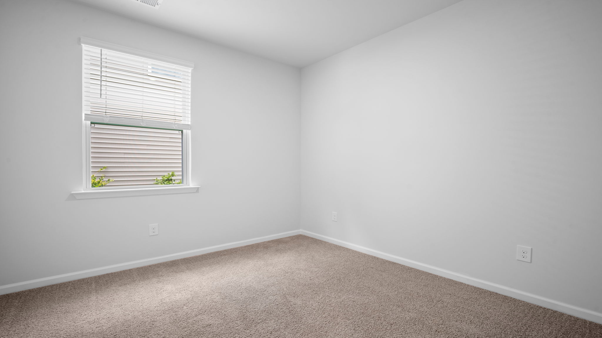 Comfortable secondary bedroom in the Greenbriar floor plan ideal for guests, children, or flexible living space.