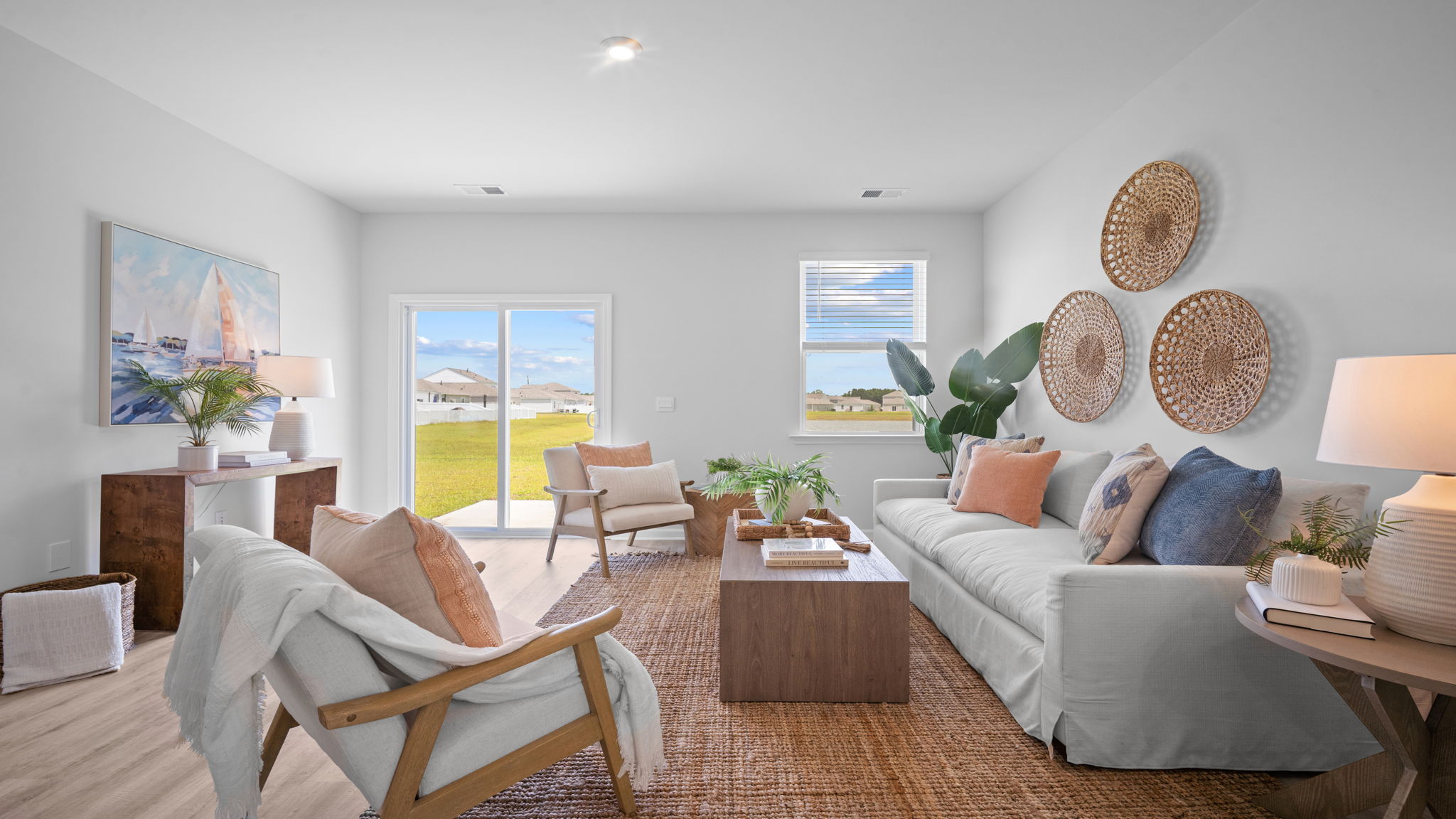 Open-concept living room in the Greenbriar floor plan featuring abundant natural light, spacious seating, and modern home design.