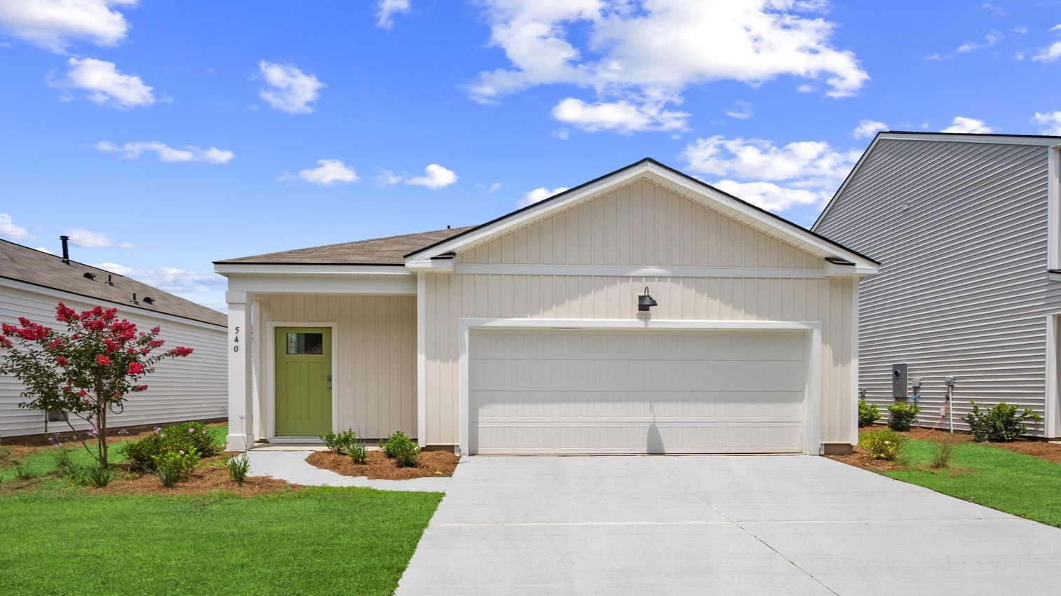 Front exterior of a single-story home with siding and a two-car garage.