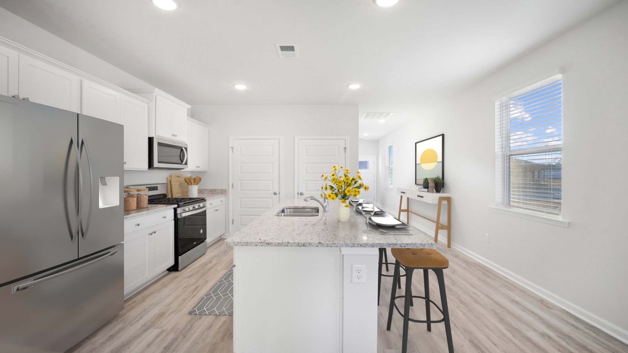 Kitchen with vinyl flooring, an island just off the entryway hall.