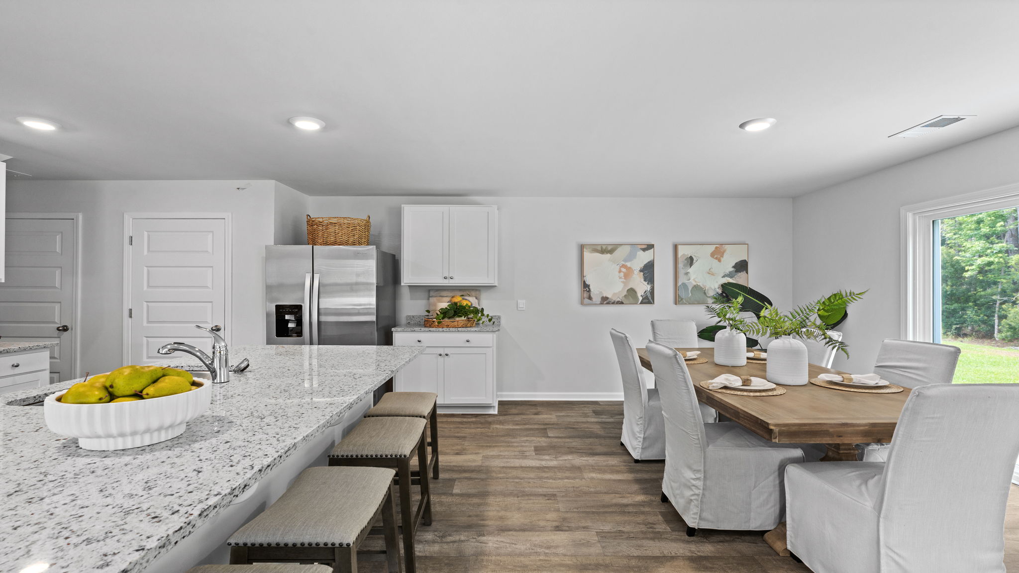 Dining area in the Downing by D.R. Horton featuring an open layout and easy kitchen access