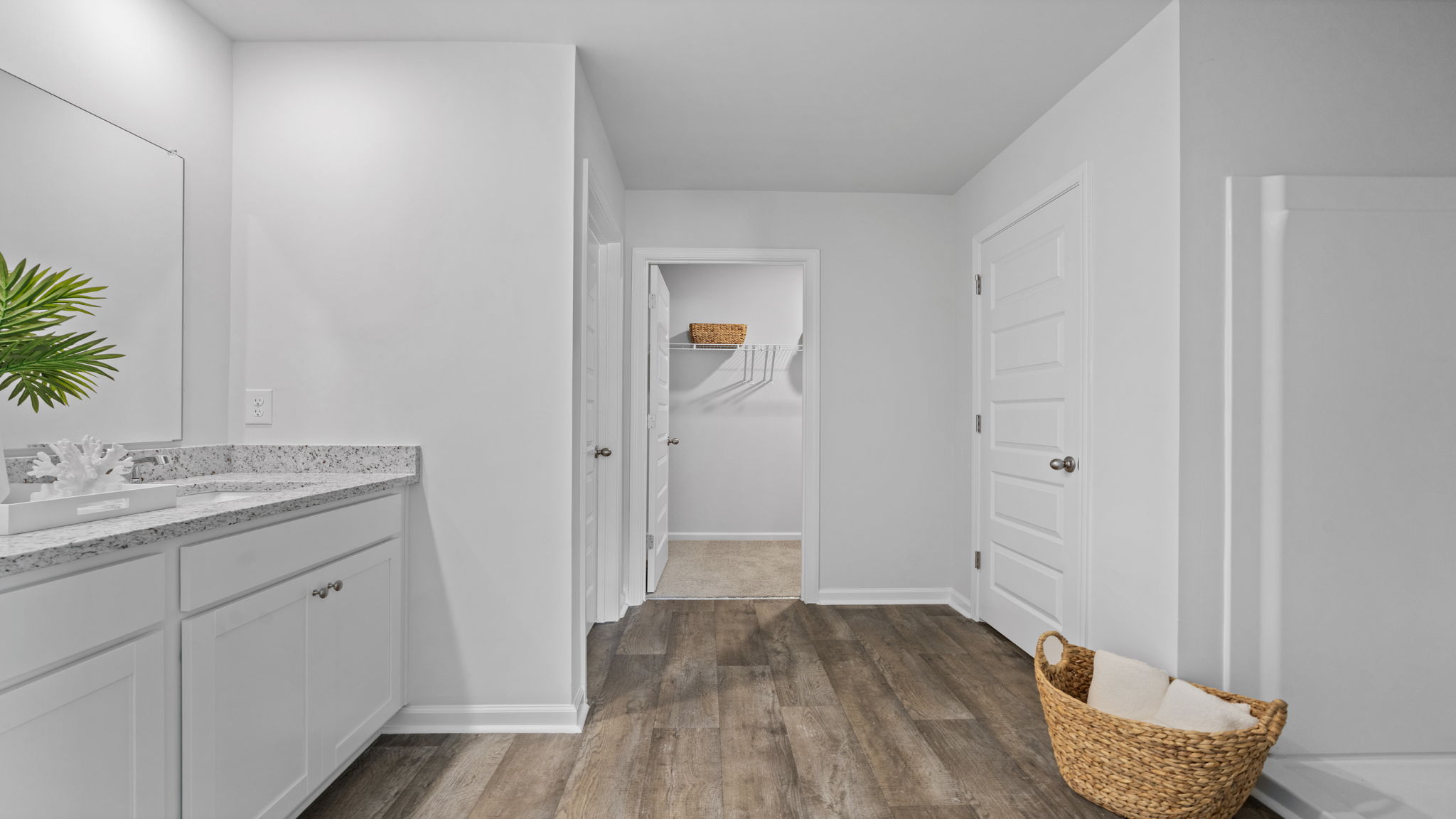 Luxurious primary bathroom in the Downing featuring dual vanities and a walk-in shower