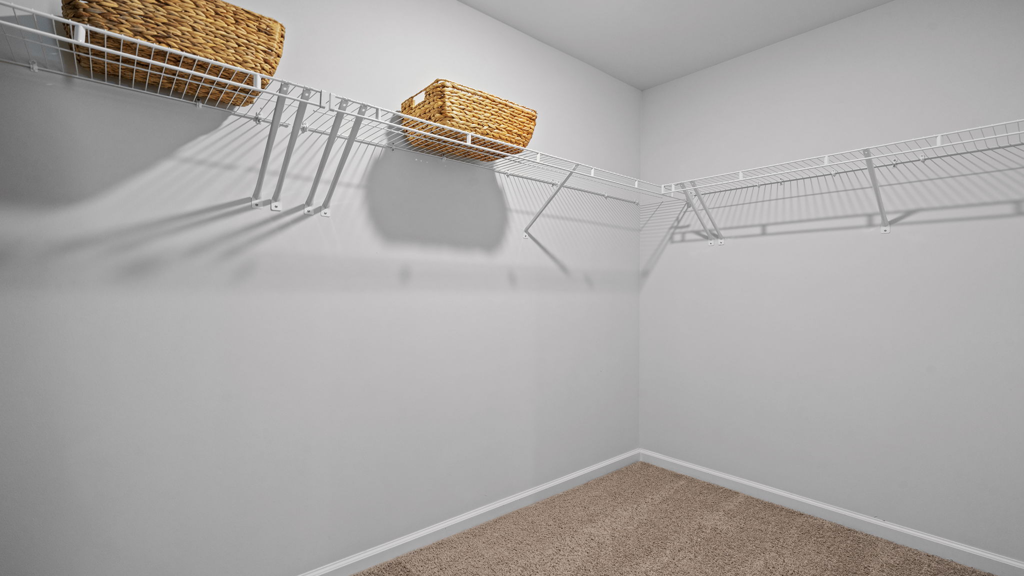 Spacious walk-in closet in the Downing primary suite offering exceptional storage space
