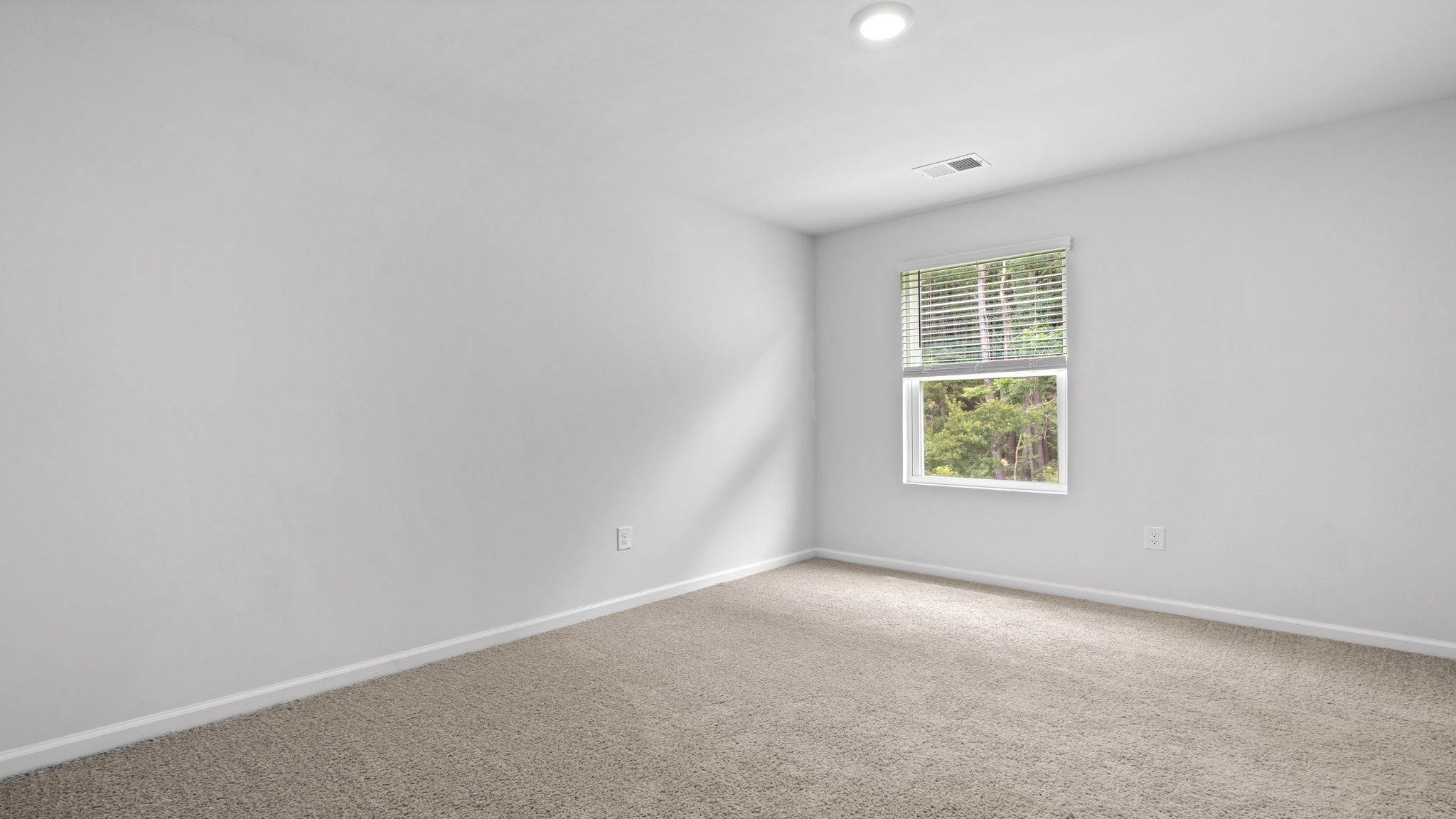 Secondary bedroom in the Downing by D.R. Horton perfect for guests, family members, or a home office