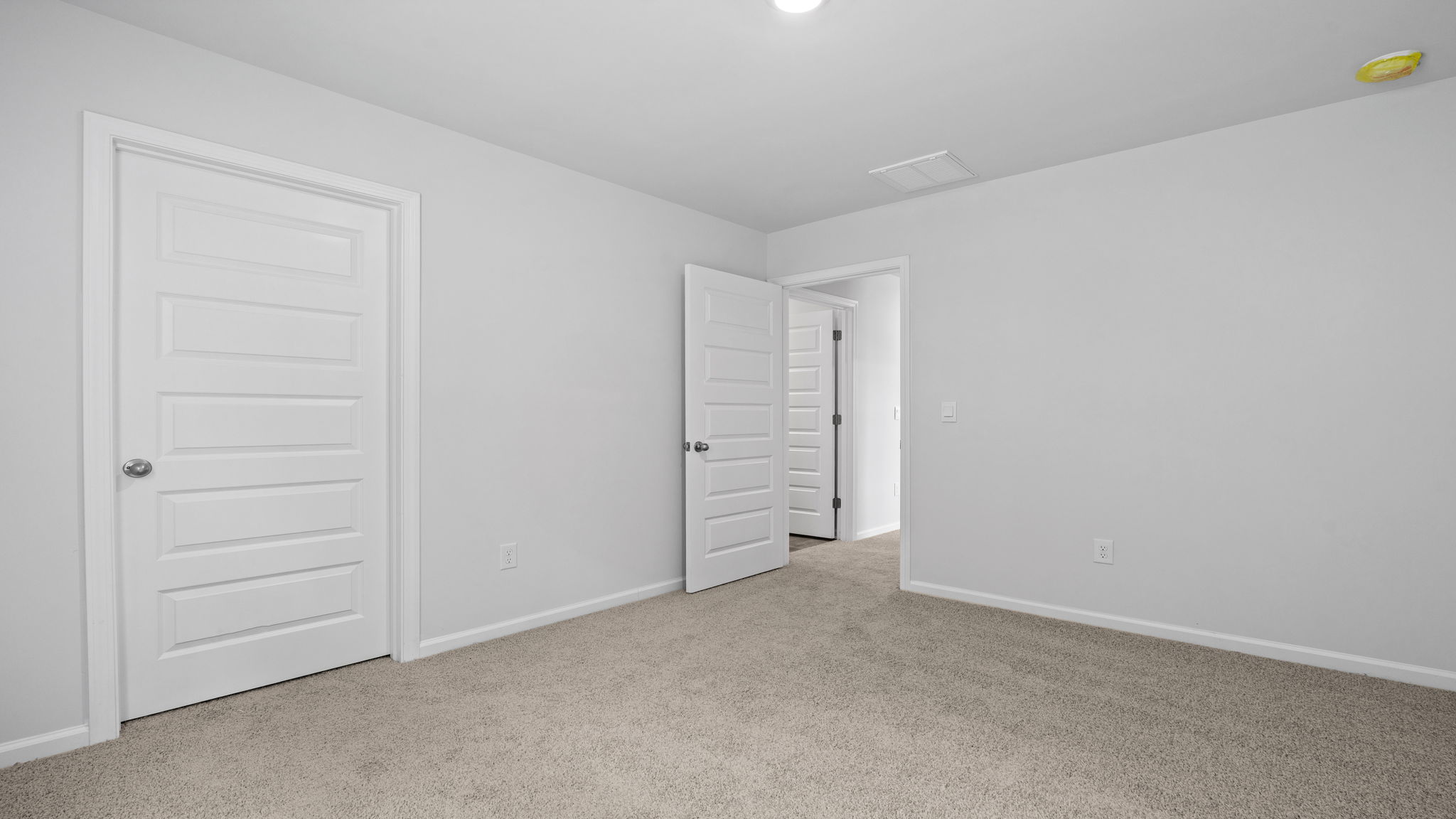 Bright guest bedroom in the Downing floor plan with versatile living options
