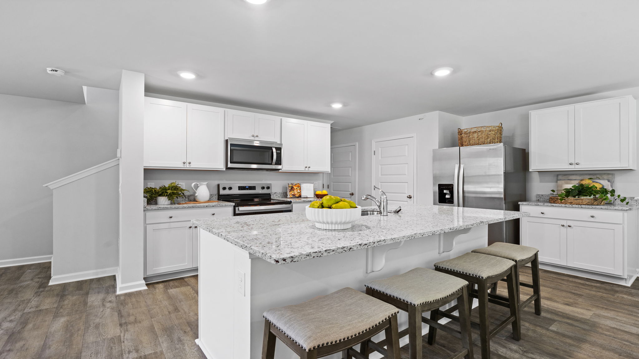 Gourmet kitchen in the D.R. Horton Downing featuring a large center island and stainless steel appliances