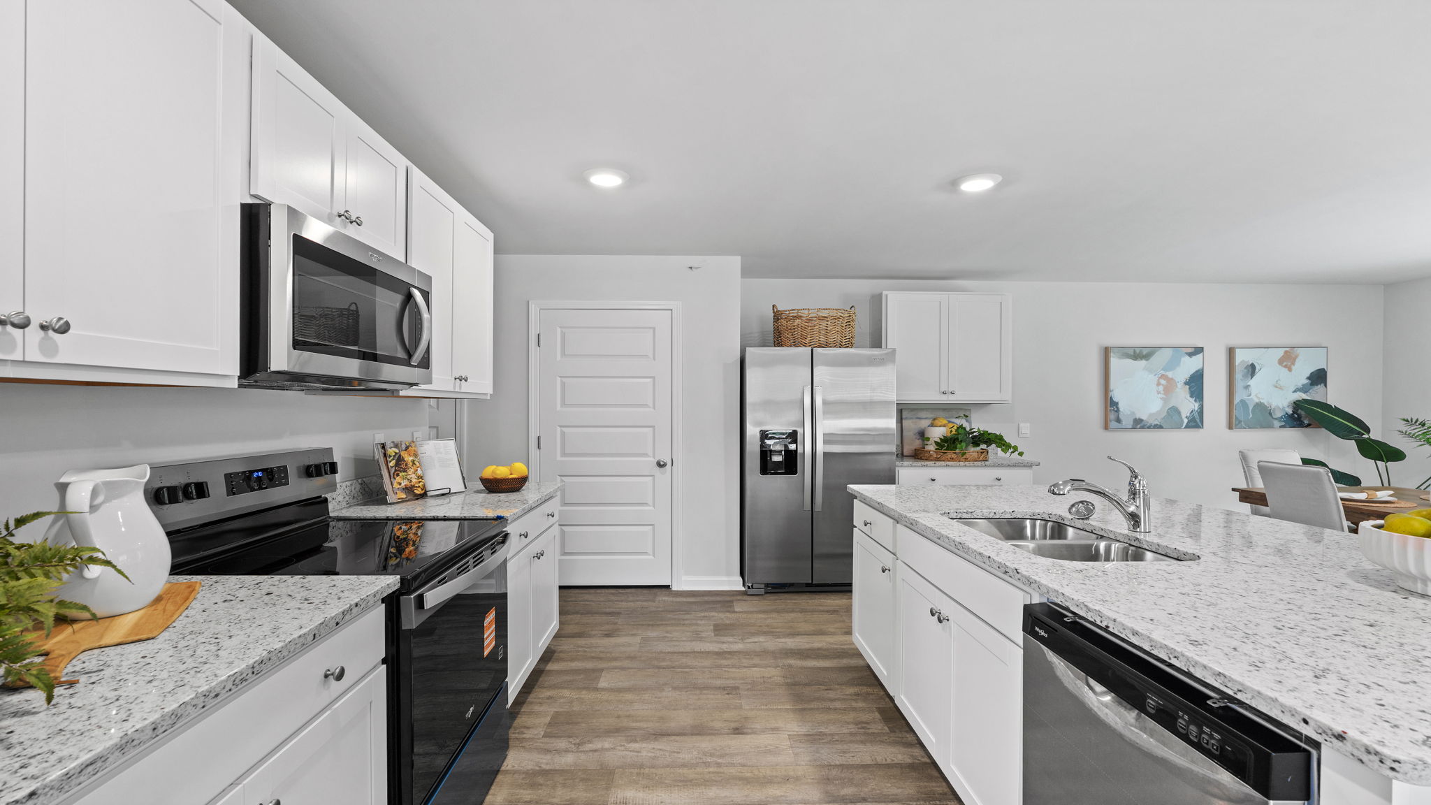Open-concept kitchen in the Downing floor plan with abundant cabinetry and casual dining space