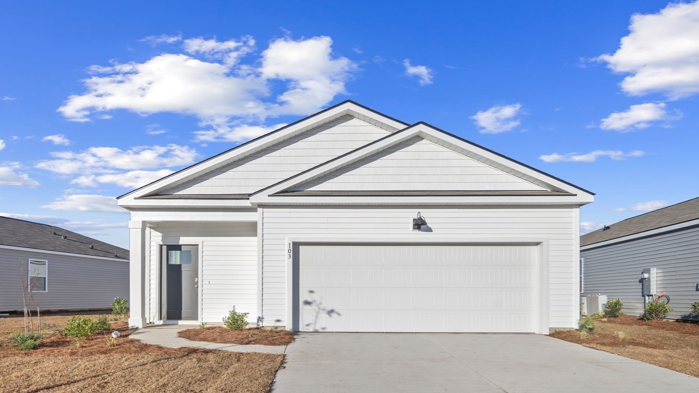 Front exterior of a single-story home with siding and a two-car garage.