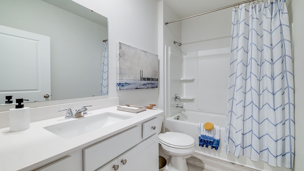 Well-appointed secondary bathroom in the Helena floor plan featuring contemporary fixtures and functional design.