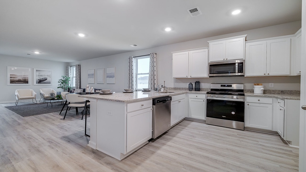 Spacious Helena floor plan kitchen featuring a large center island, modern cabinetry, stainless steel appliances, and open-concept living.