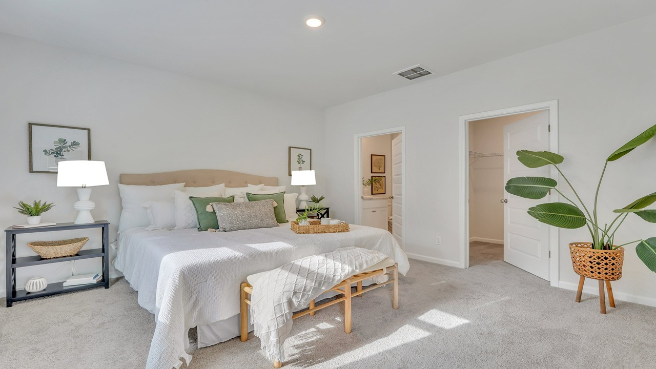 Elegant owner's suite in the Helena home featuring comfortable living space and modern design details