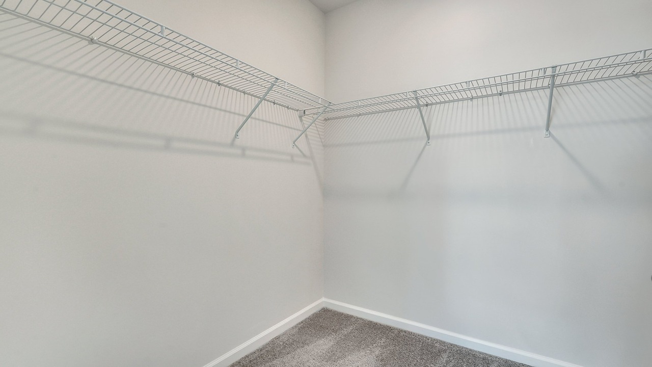 Generous walk-in primary closet in the Helena floor plan at East Argent offering ample storage and organization space