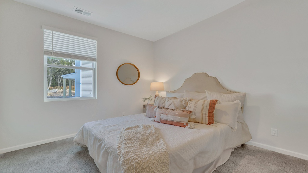 Comfortable guest bedroom in the Helena floor plan at East Argent featuring natural light, spacious layout, and modern finishes