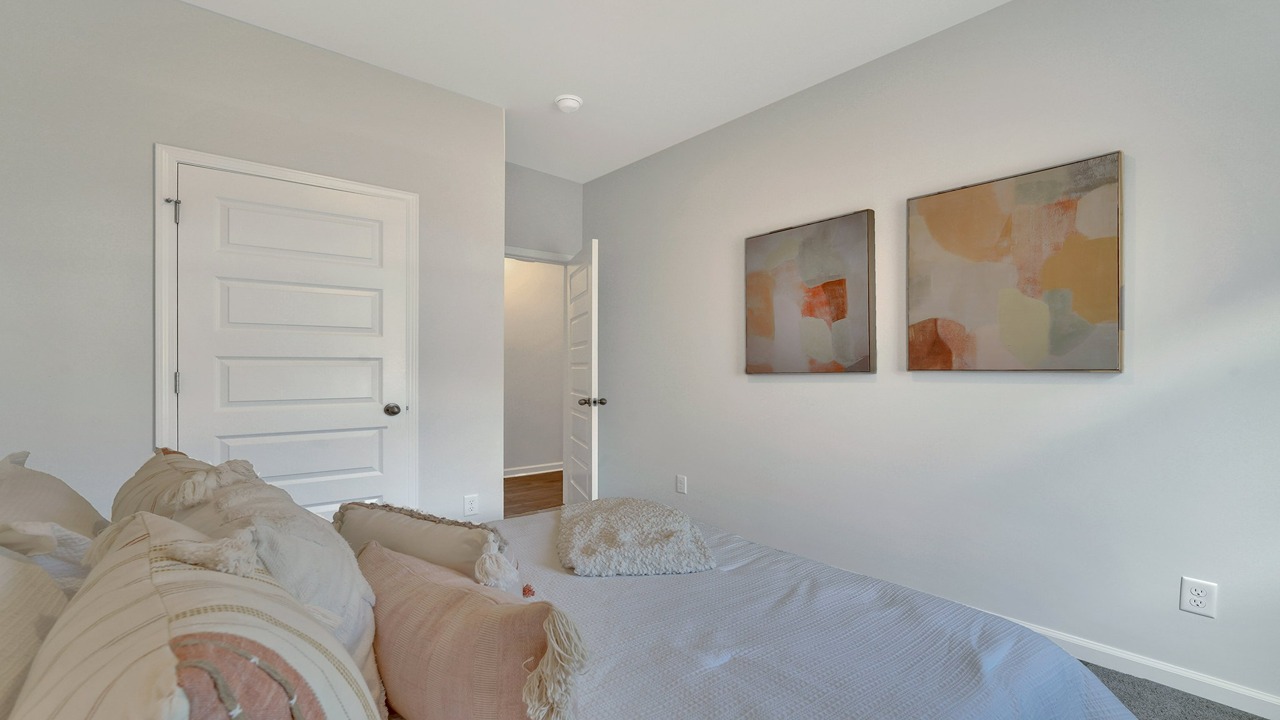 Inviting secondary bedroom in the Helena home at East Argent designed for guests, family, or a home office
