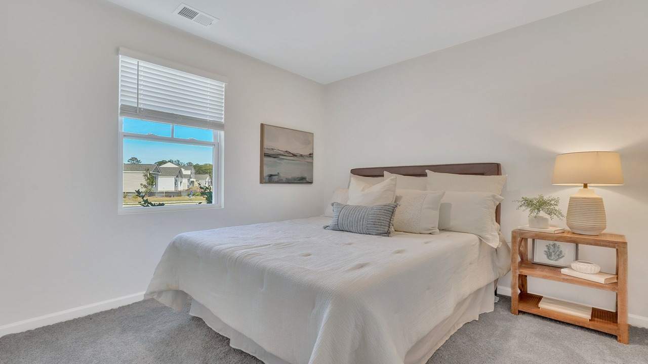 Well-appointed guest bedroom in the Helena at East Argent offering flexibility, comfort, and stylish design