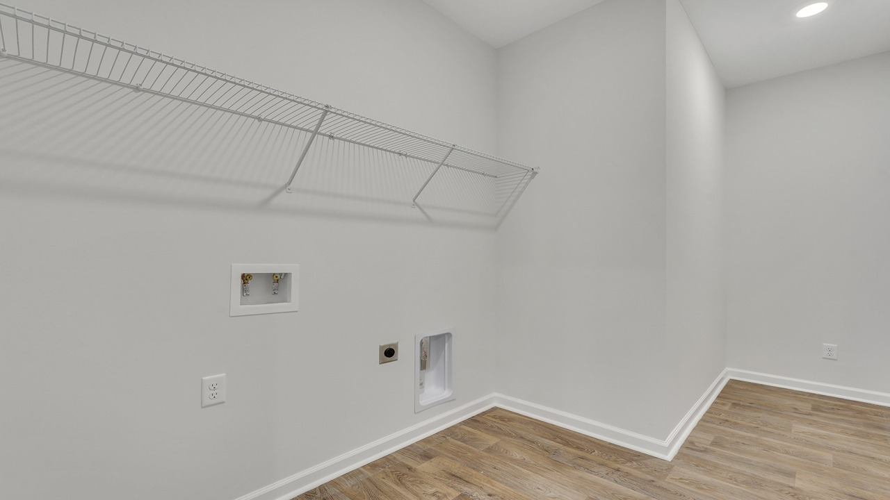 Convenient laundry room in the Helena floor plan at East Argent featuring dedicated utility space and functional storage options