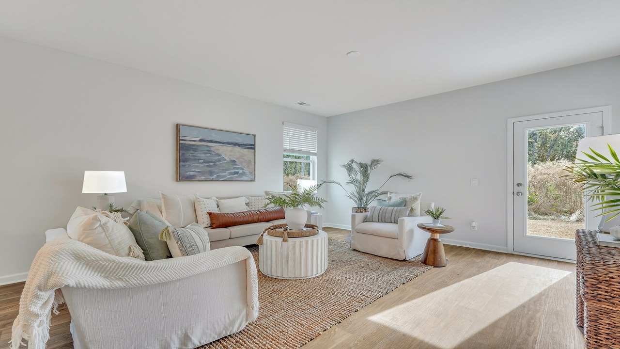 Helena home living room featuring open layout, designer flooring, and seamless flow to kitchen and dining areas