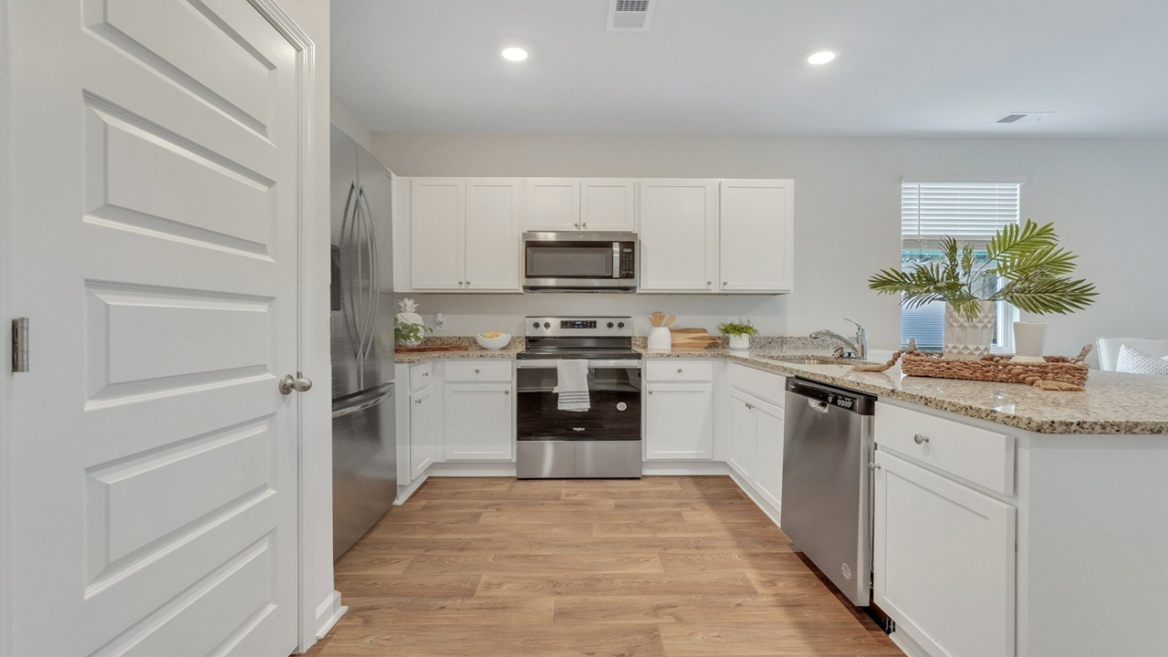 Open-concept Helena kitchen featuring quartz countertops, pendant lighting, and spacious island seating