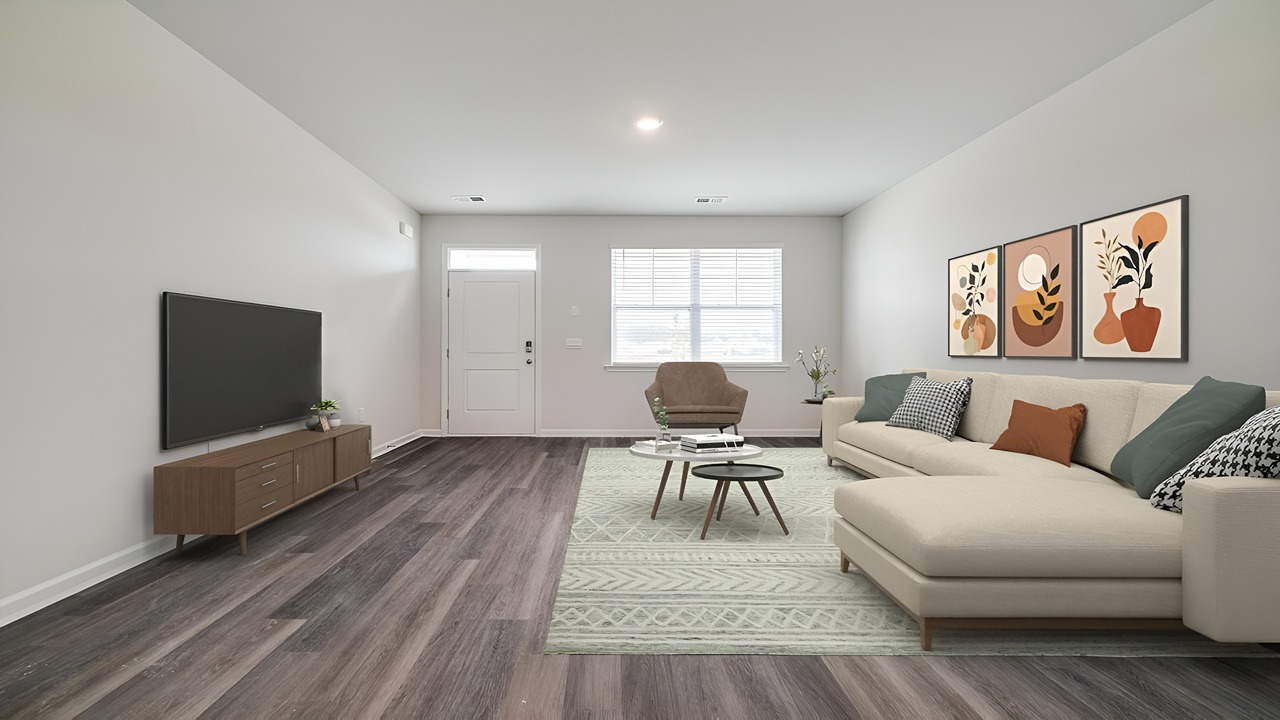 Spacious living room in the Brandon floor plan featuring abundant natural light, open-concept design, and convenient access to the kitchen and dining area.