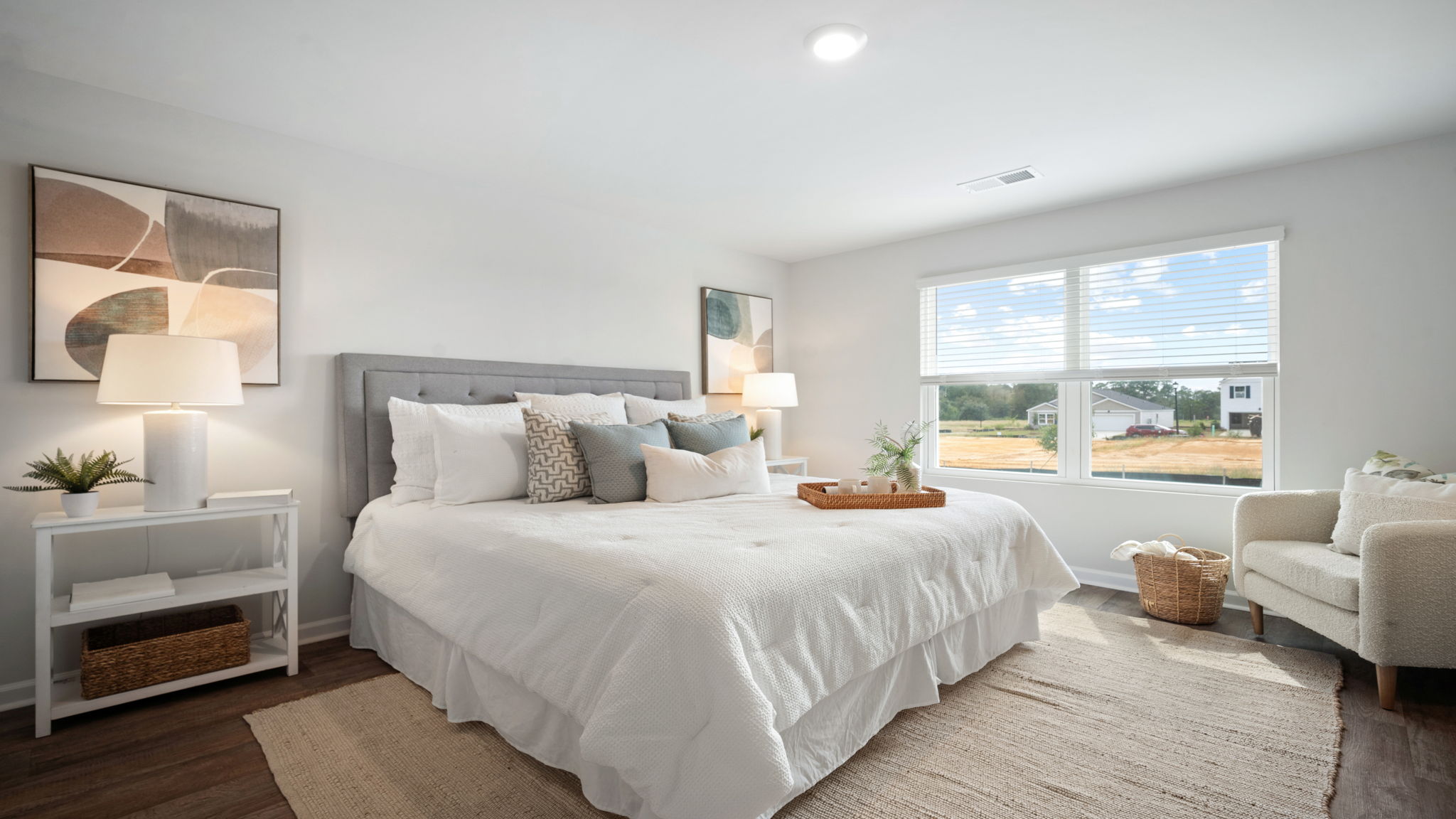 Primary bedroom decorated with a bed, bench, side table and seating