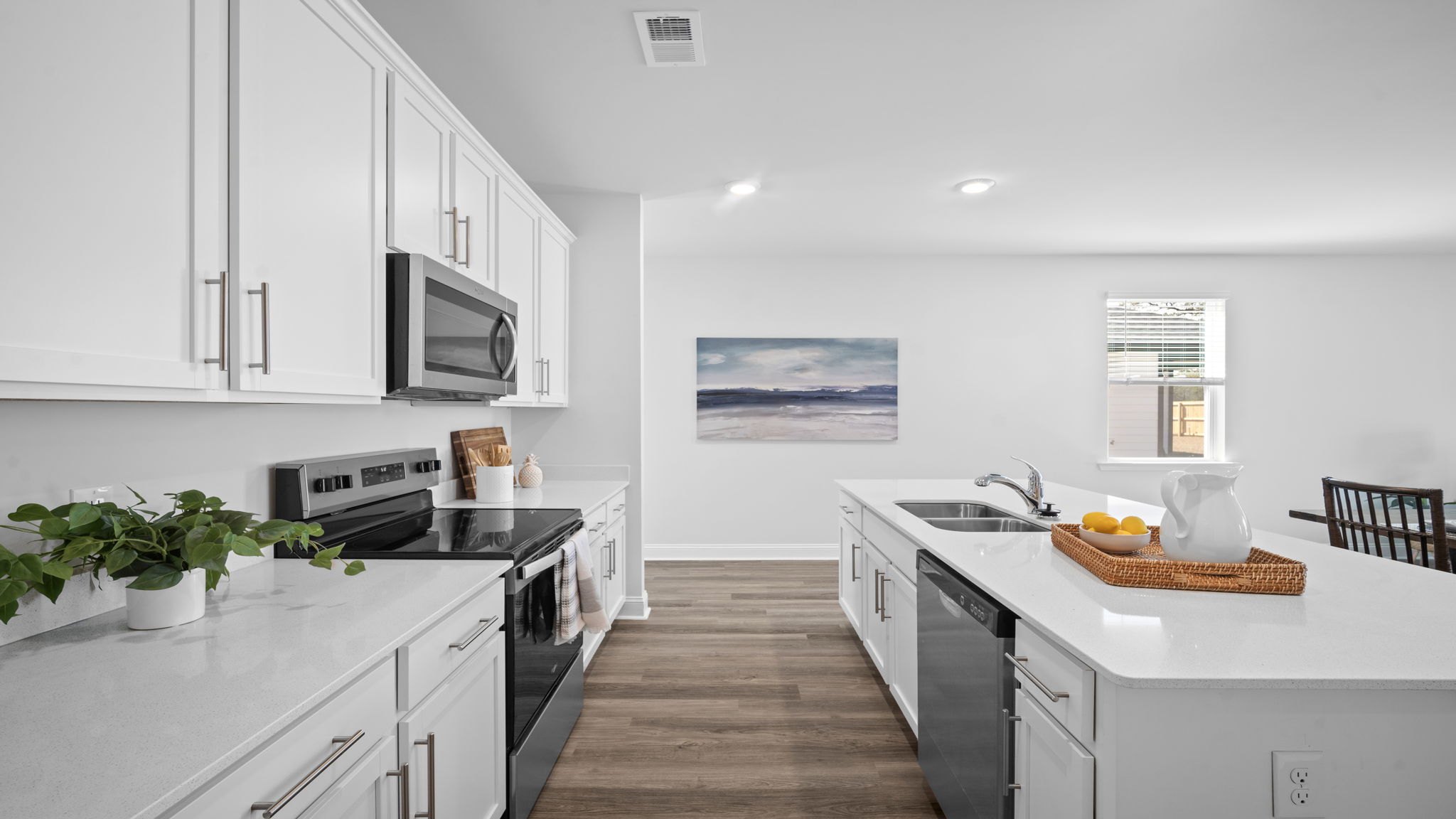 Open-concept kitchen with stylish finishes and convenient access to the dining area.