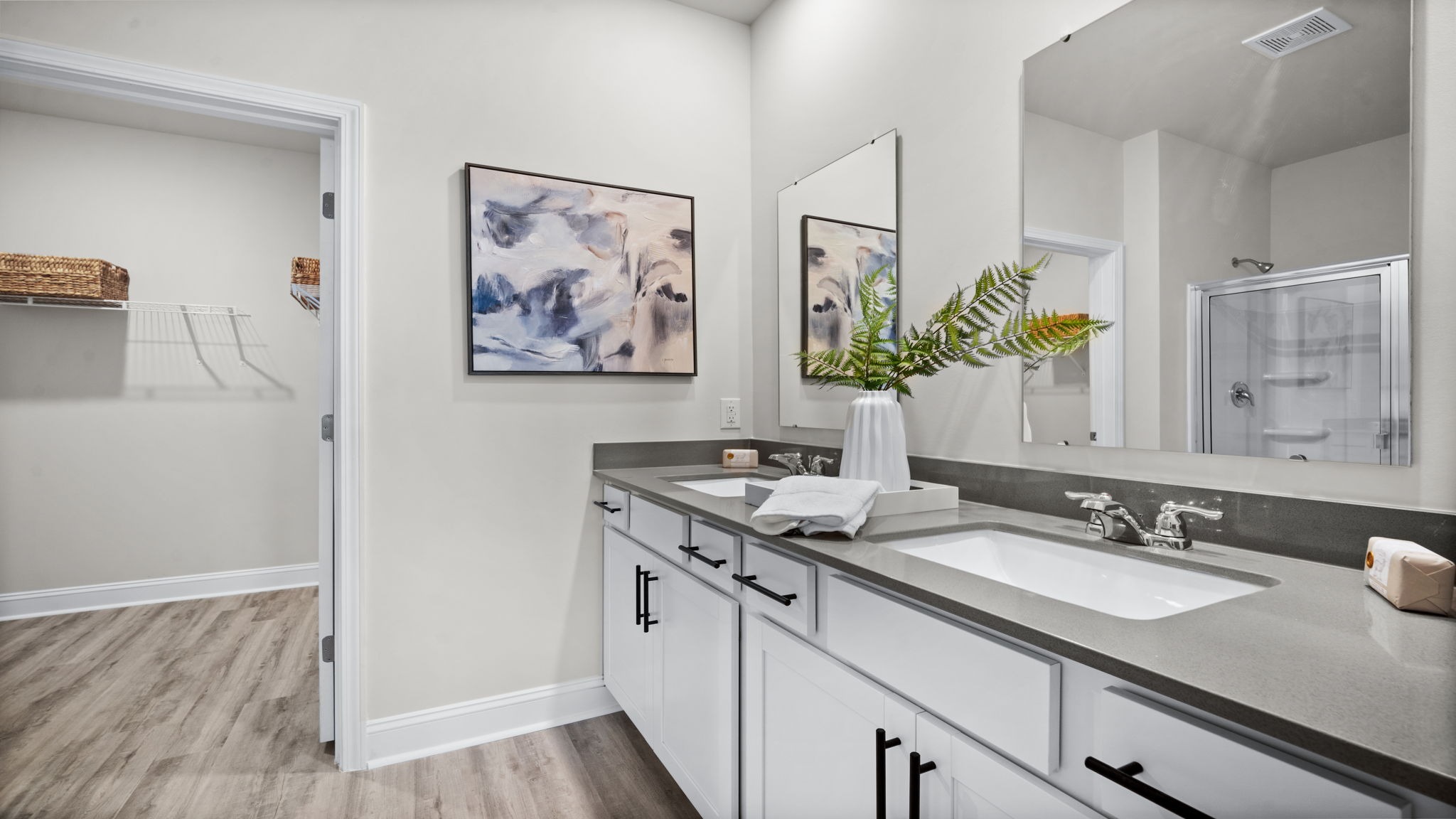 Primary bathroom in Manning model featuring dual vanities and modern finishes for everyday comfort