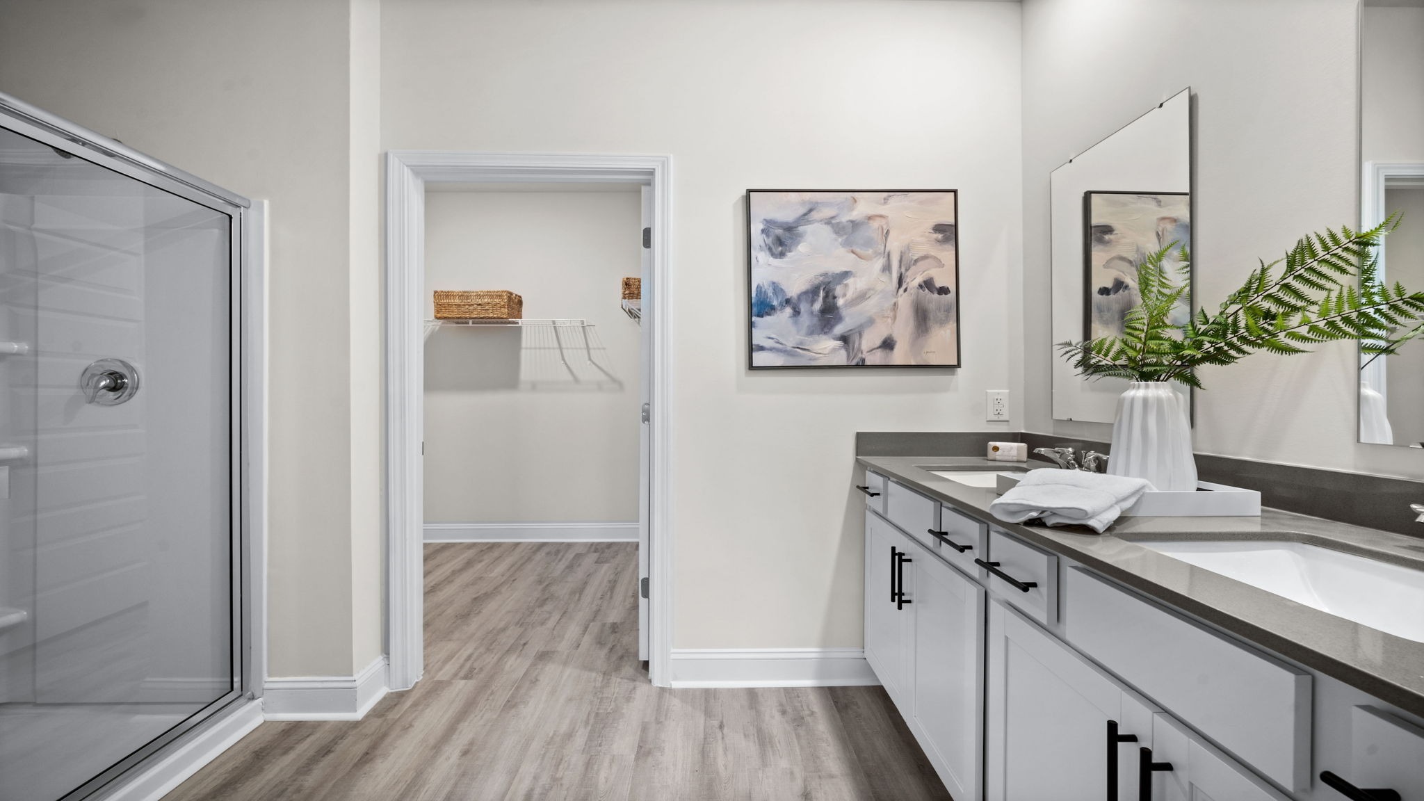 Primary bathroom in Manning model featuring dual vanities and modern finishes for everyday comfort