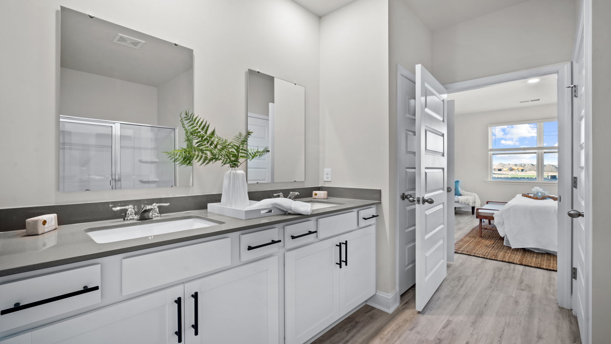 Primary bathroom in Manning model featuring dual vanities and modern finishes for everyday comfort