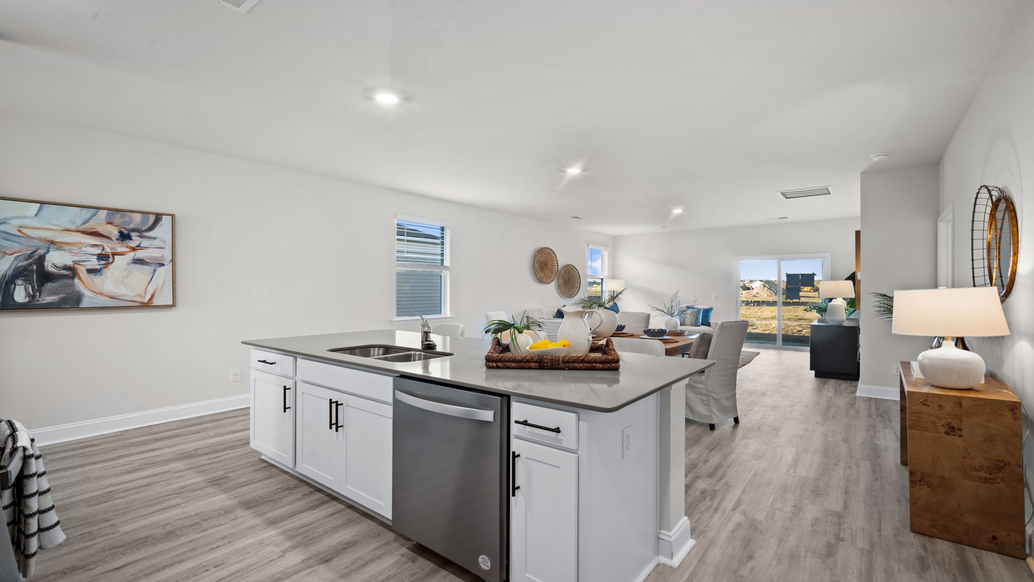 “Modern kitchen in Manning floor plan featuring large center island, natural gas appliances, and open layout for entertaining.”