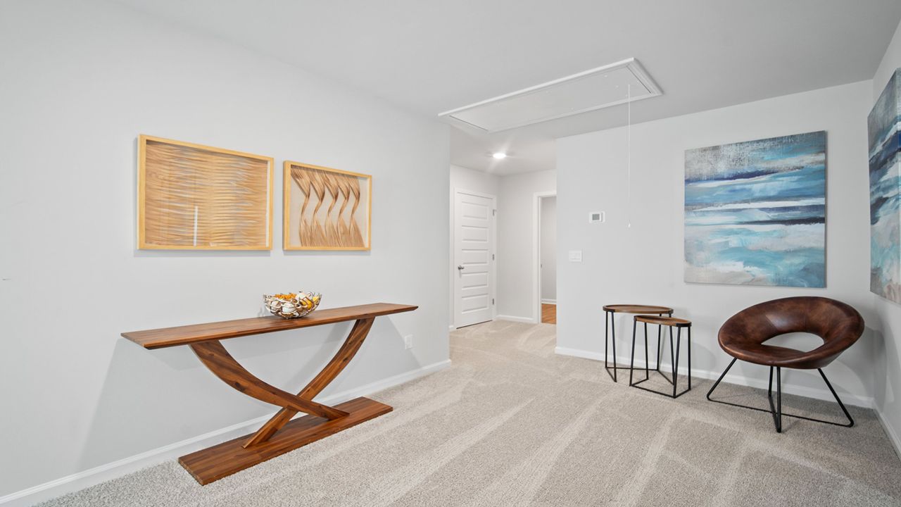 Upstairs loft decorated with a chair and table